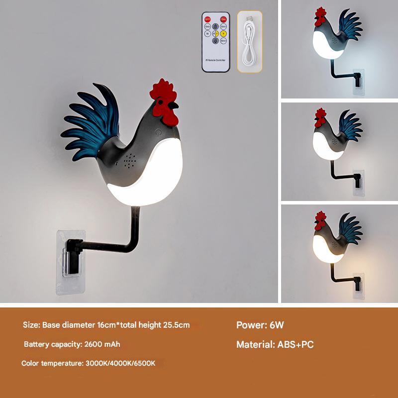 Rooster wall lamp with glowing bulb, red head, blue tail feathers on black arm