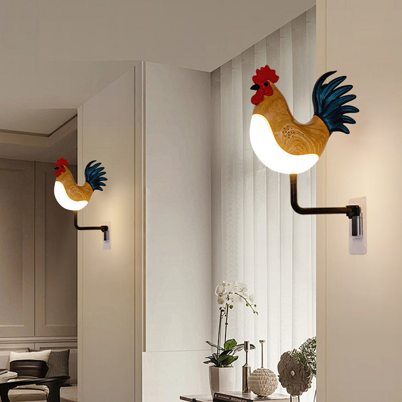 Rooster wall lamps with glowing bulbs, wood rooster with red comb and blue tail, black arms