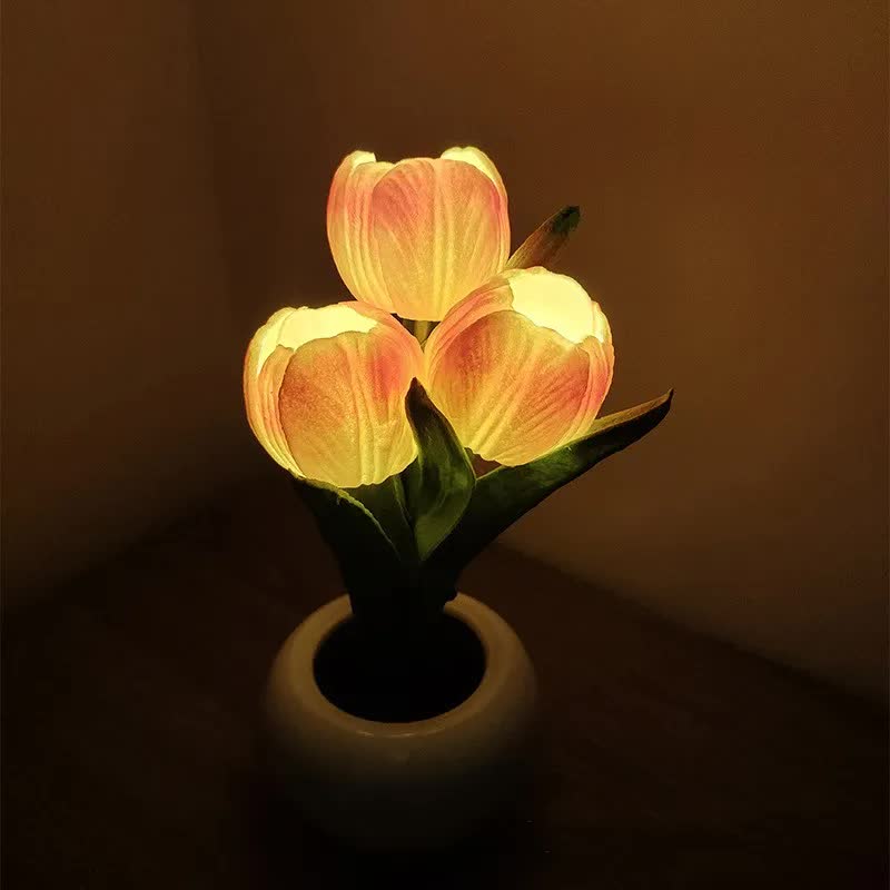 Tulip night light with orange-and-yellow faux tulips in a dark ceramic pot