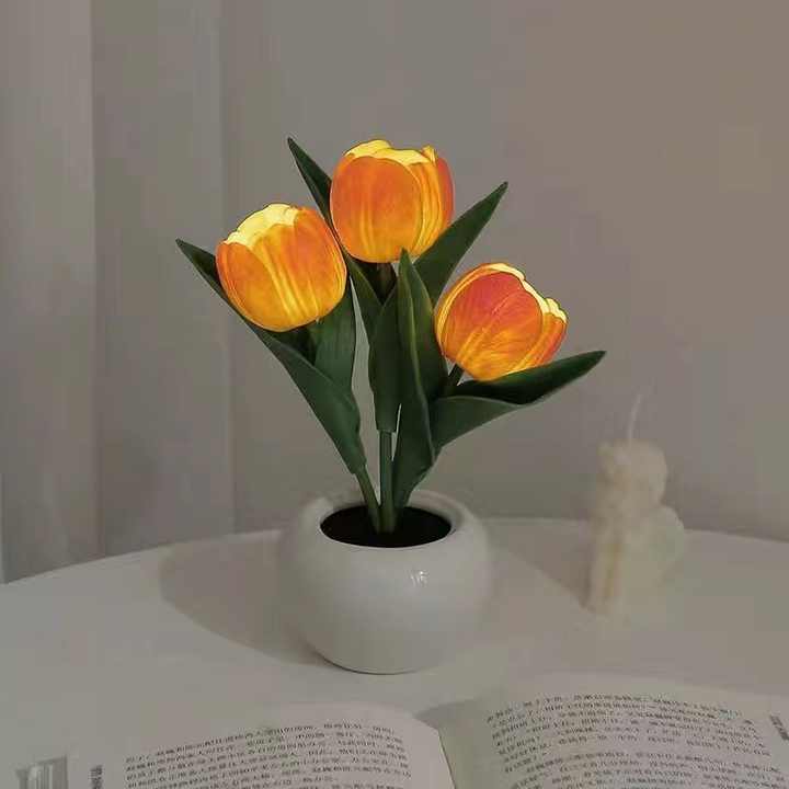 Tulip night light with orange faux tulips in a white ceramic pot