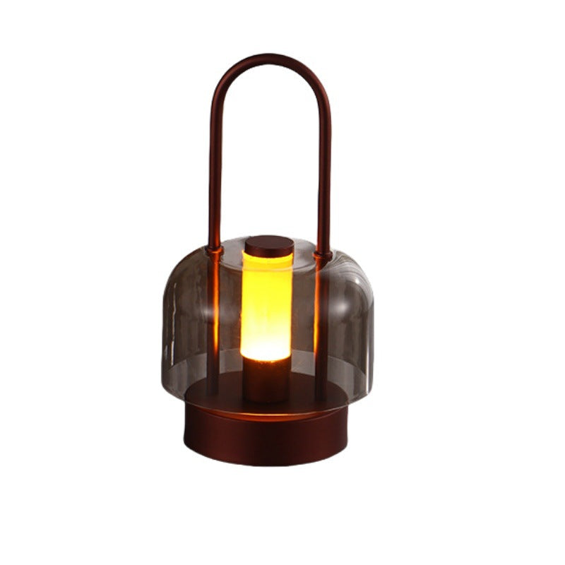 Rechargeable LED lantern in brown with handle and glowing lamp inside
