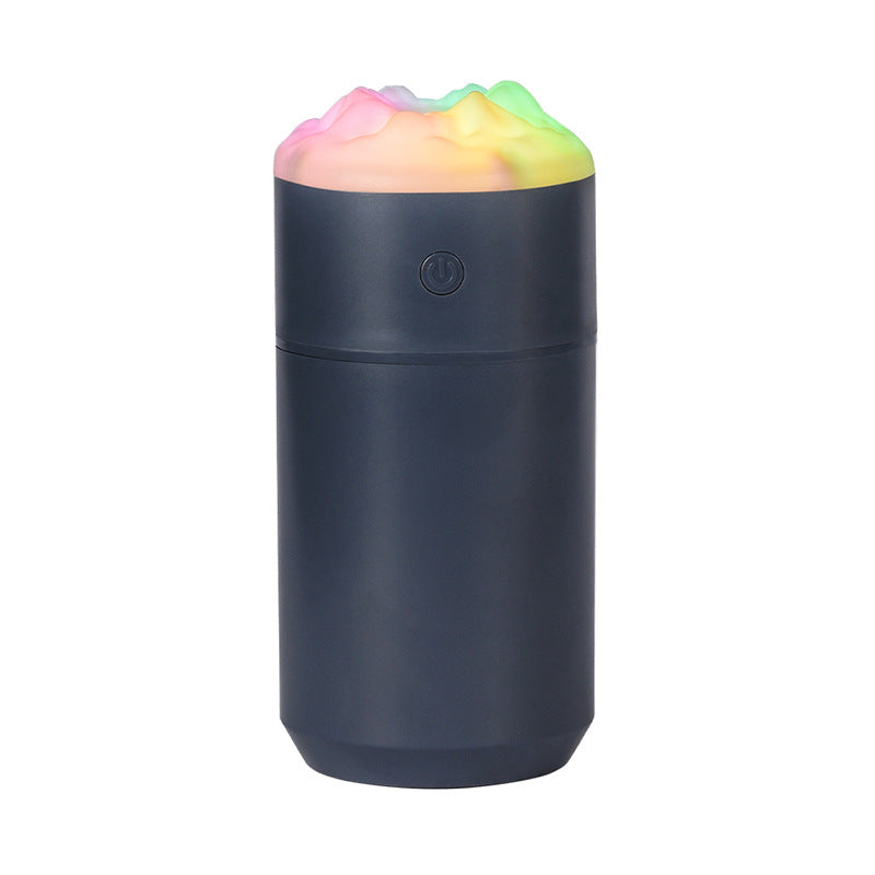 Portable desk humidifier, dark blue cylindrical body with glowing rainbow top