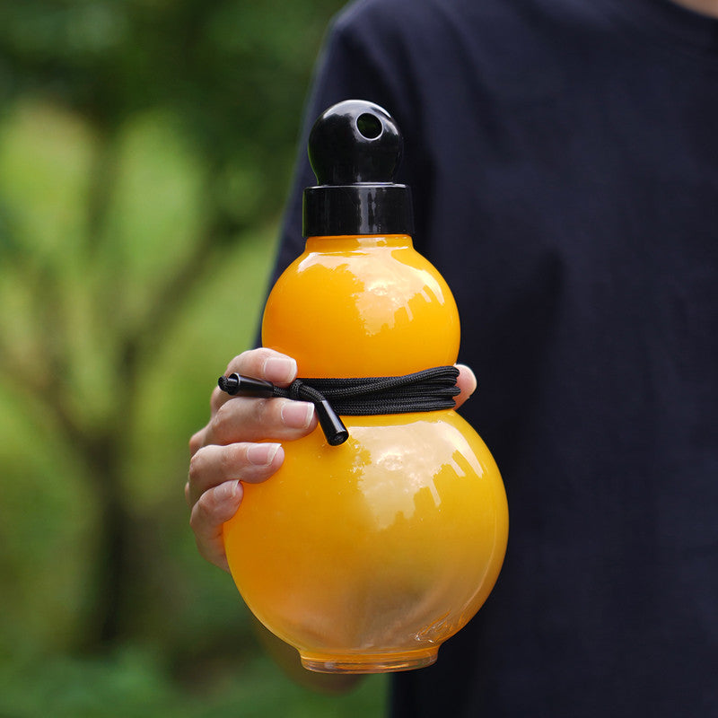 Yellow gourd-shaped plastic water bottle with black screw lid and carrying strap