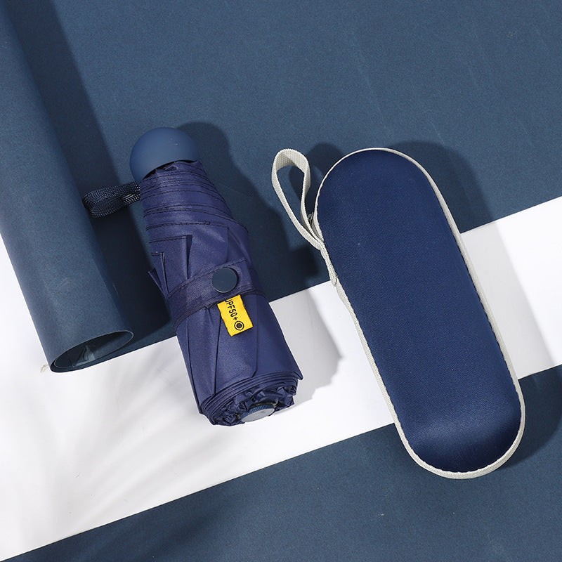 Navy blue compact 5-fold umbrella with carry strap, folded closed