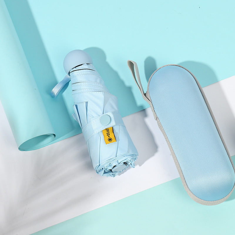 Sky blue compact folding umbrella with sleeve and strap, closed view