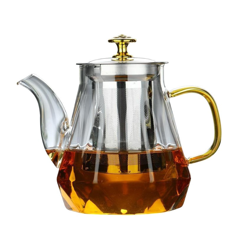 Glass teapot with gold handle and stainless infuser top, amber liquid inside