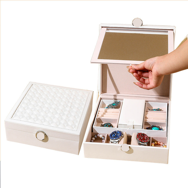 White quilted jewelry box with hinged lid and open multi-compartment layout