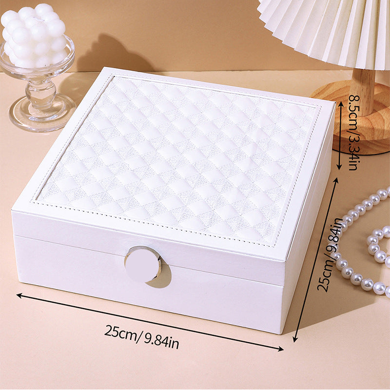 White quilted jewelry storage box with heart-shaped front latch and open lid