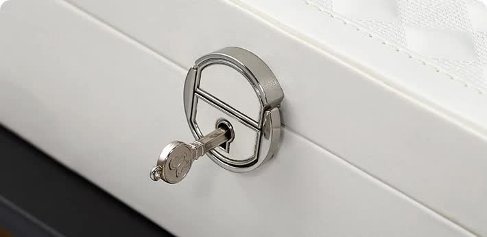 Metal lock clasp on white jewelry storage box lid edge