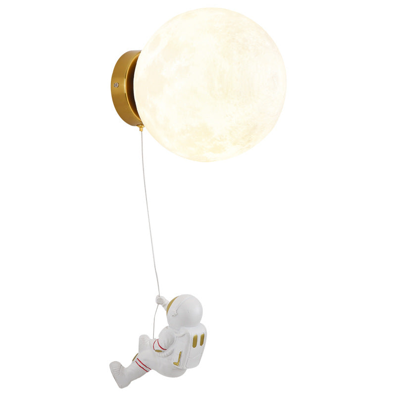 Astronaut moon wall lamp with pale globe shade and bronze mount, astronaut figure on long cord