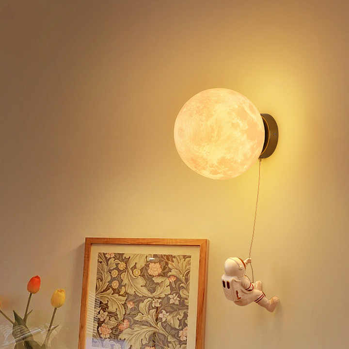 Astronaut moon wall lamp with round moon shade and hanging astronaut on cord