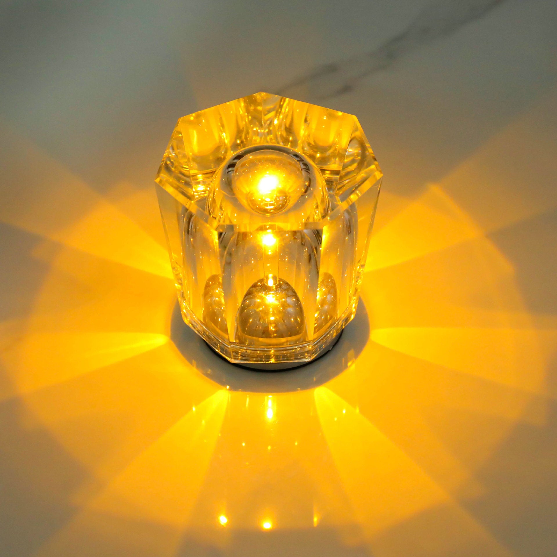 Amber crystal LED table lamp with starburst light and circular base