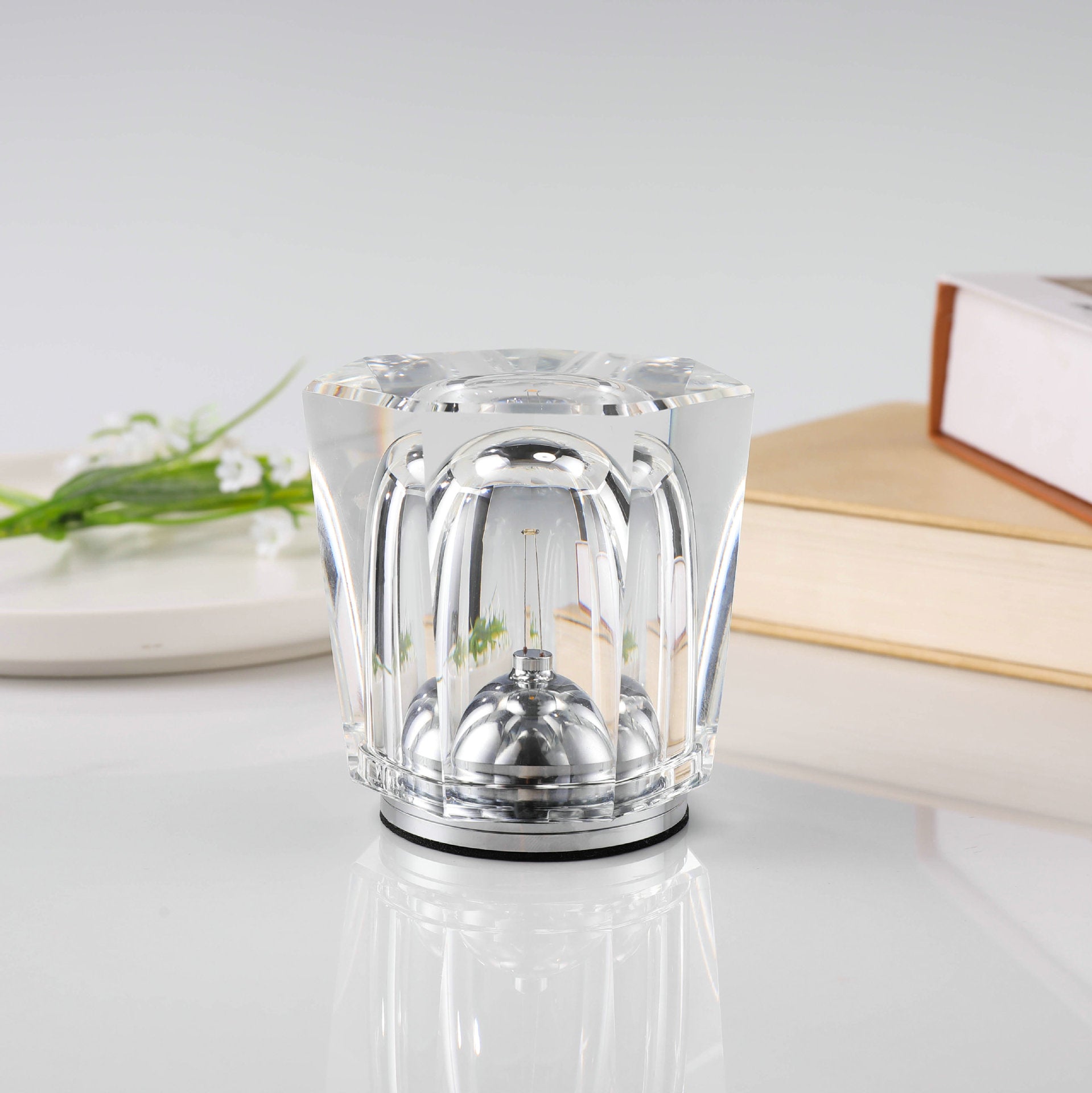 Clear crystal LED table lamp with metal base and visible glowing bulb