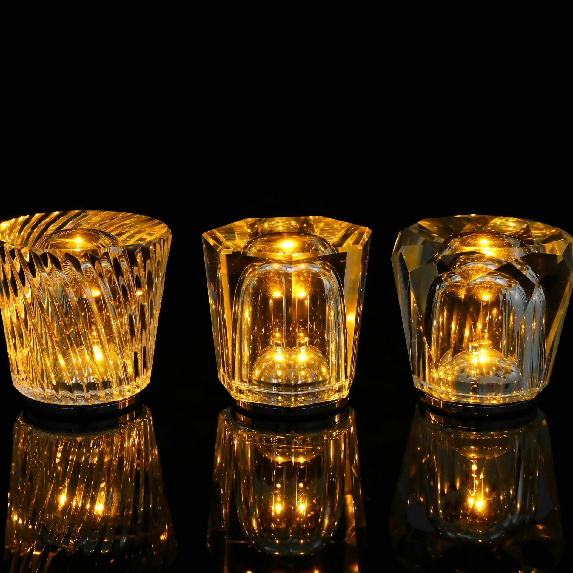 Crystal LED table lamp shown from three angles with amber light inside faceted shade