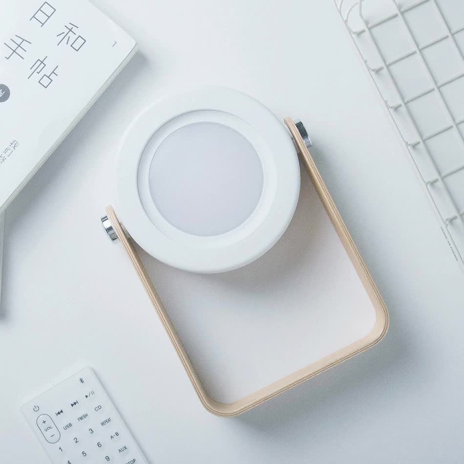White and gray lantern desk lamp with round diffuser and wooden-look frame, top angle
