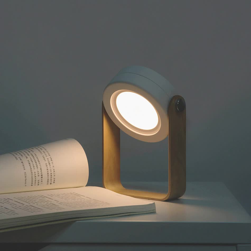 Lantern-style desk lamp with warm circular light and dark blue frame