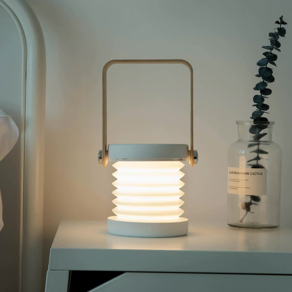Ribbed lantern-style desk lamp with warm light and top carrying handle