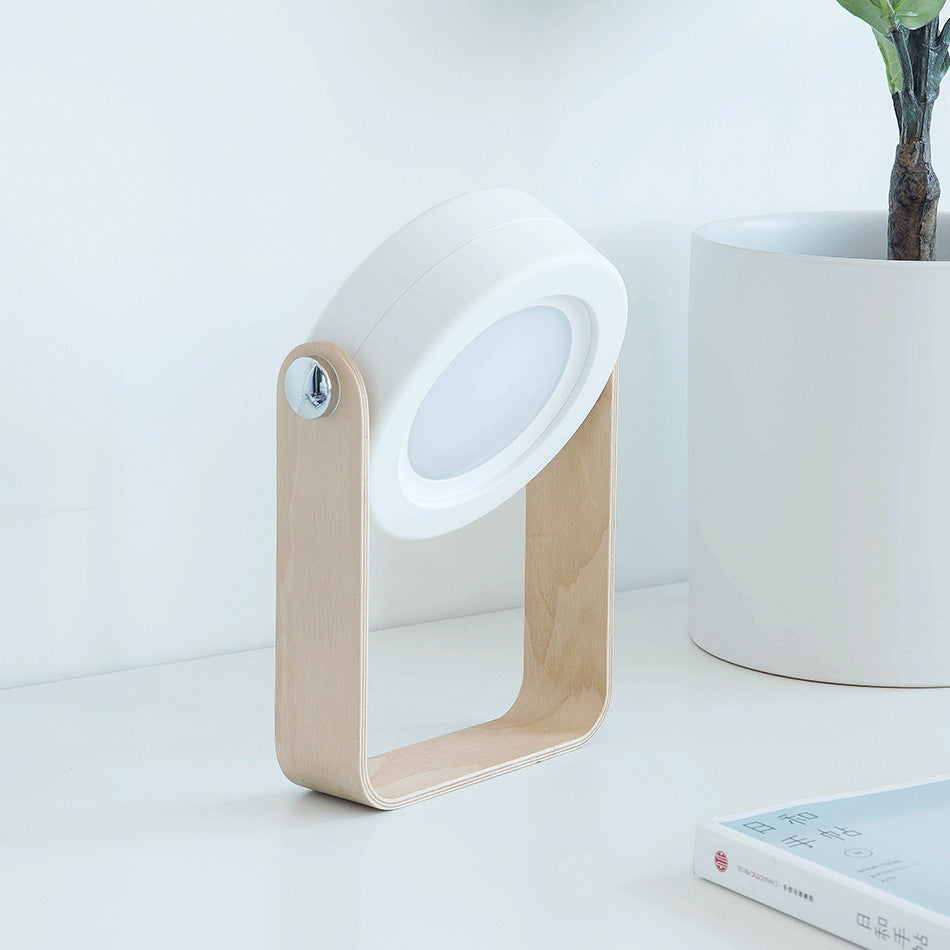 Wood-frame lantern desk lamp with white circular opening and arched base.