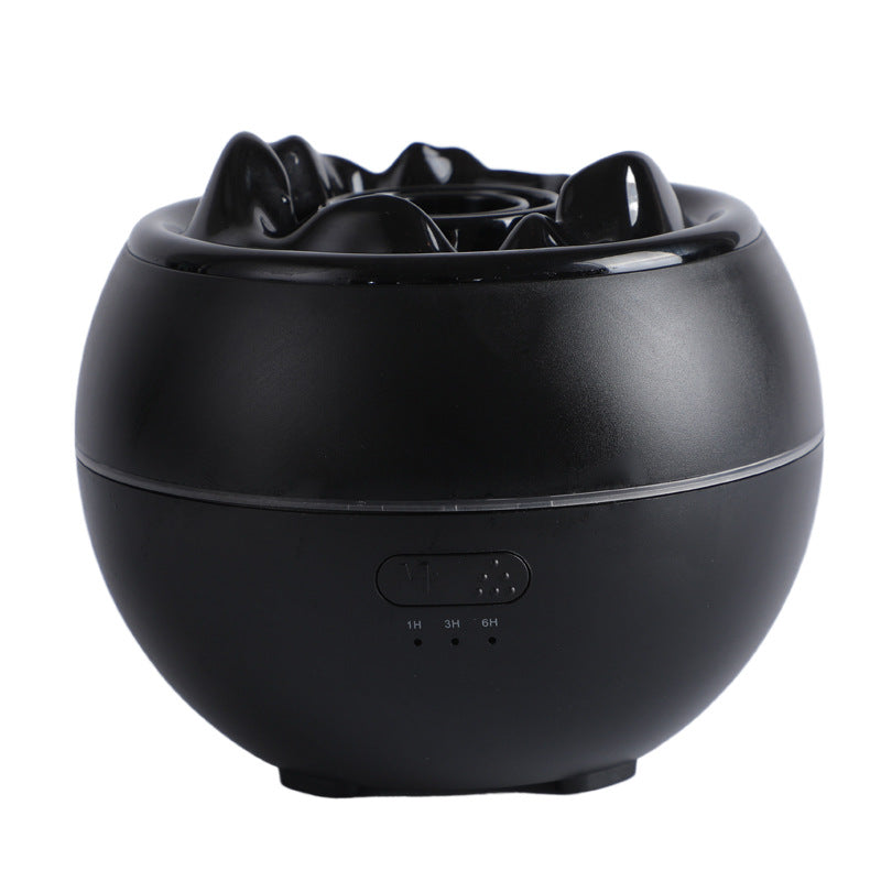 Black aroma diffuser humidifier with flame-style top and control buttons