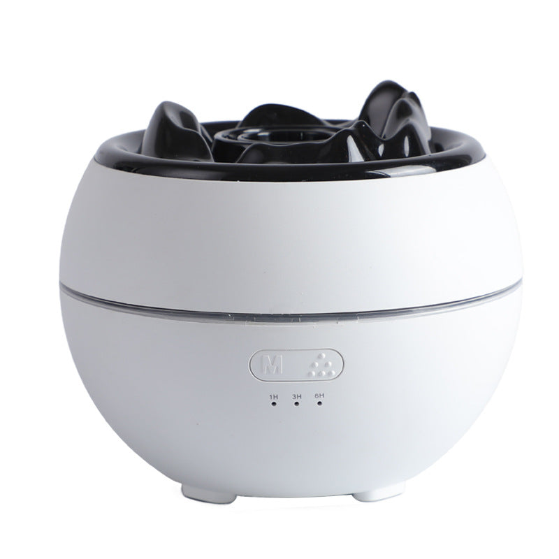 White aroma diffuser with black flame-style top and mist control buttons