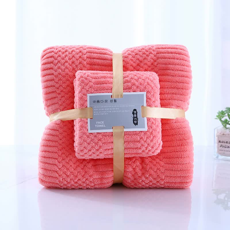 Coral fleece towel set, folded bath towels with stitched edges and tan strap labels