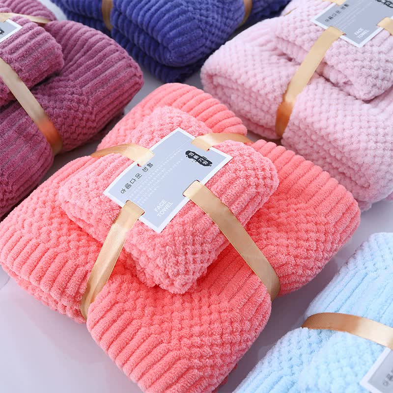 Fleece towel set with bundled textured towels in coral and pink tones, tied with straps