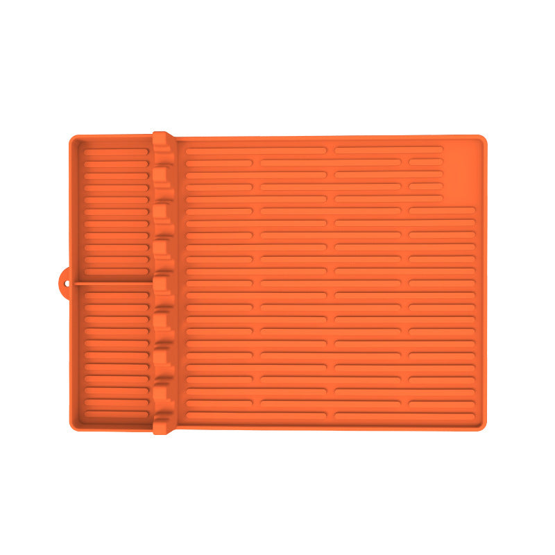 Orange silicone grilling mat with ridged texture and side rail for BBQ racks
