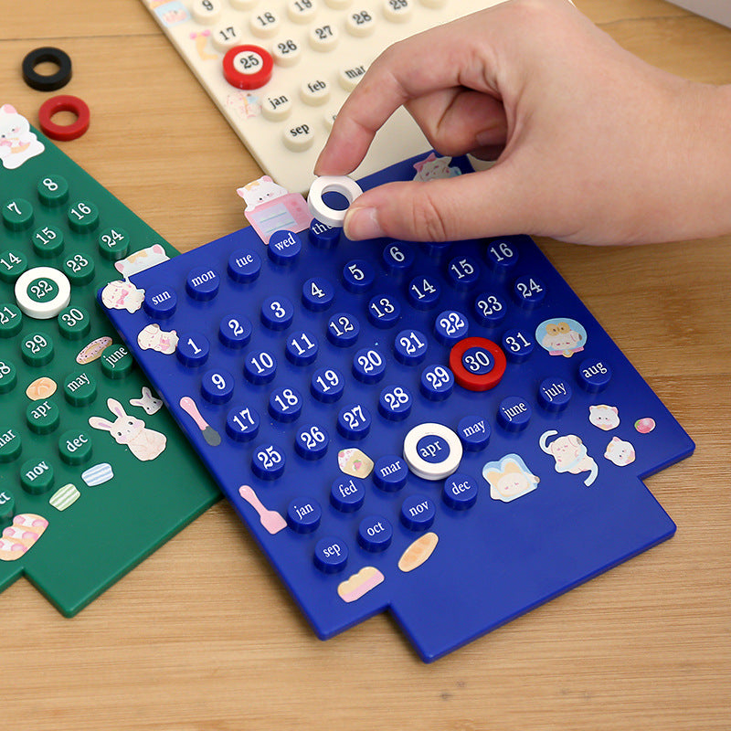 Blue and green perpetual calendars with numbered ring discs, adjusted by hand
