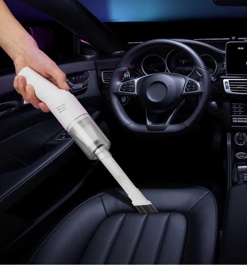 White handheld vacuum cleaner cleaning car seat and dashboard area