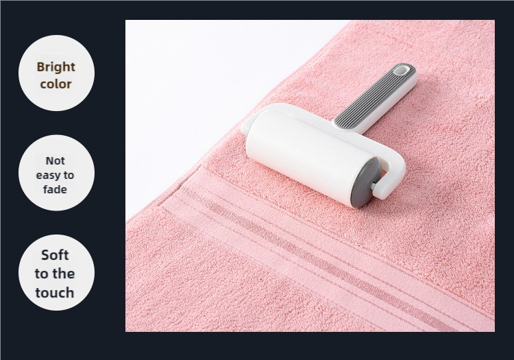 Pink cotton towel with grooming roller tool detail on terry surface