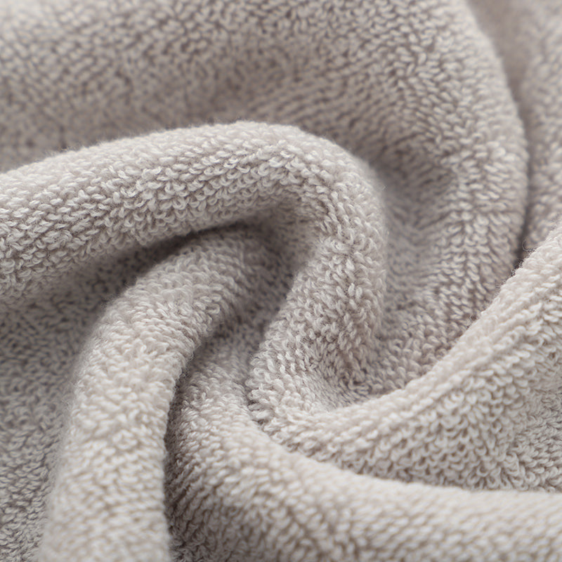 Light gray terry bath towel with looped fabric texture, folded for display