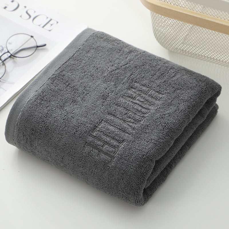 Dark gray bath towel roll with embossed “HAPPY” lettering, soft terry weave