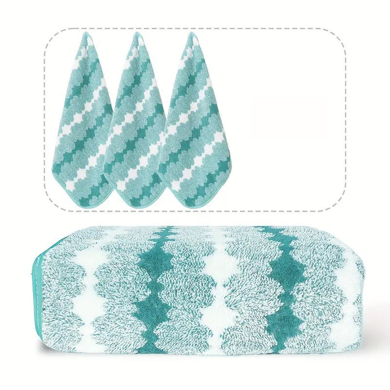 Light blue towel with white clover-style pattern, folded