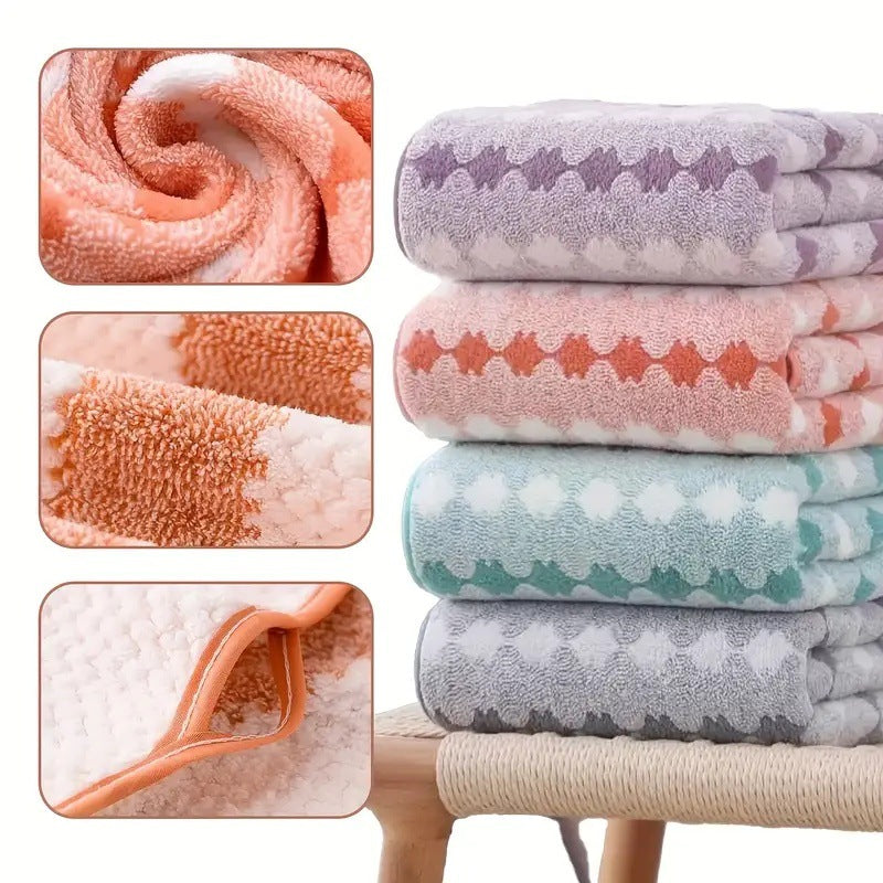 Fleece towel set stack with rolled towels in pastel purple, orange, teal, and gray