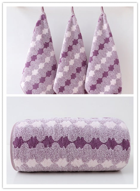 Purple coral fleece towel set with rolled towel and three patterned hand towels