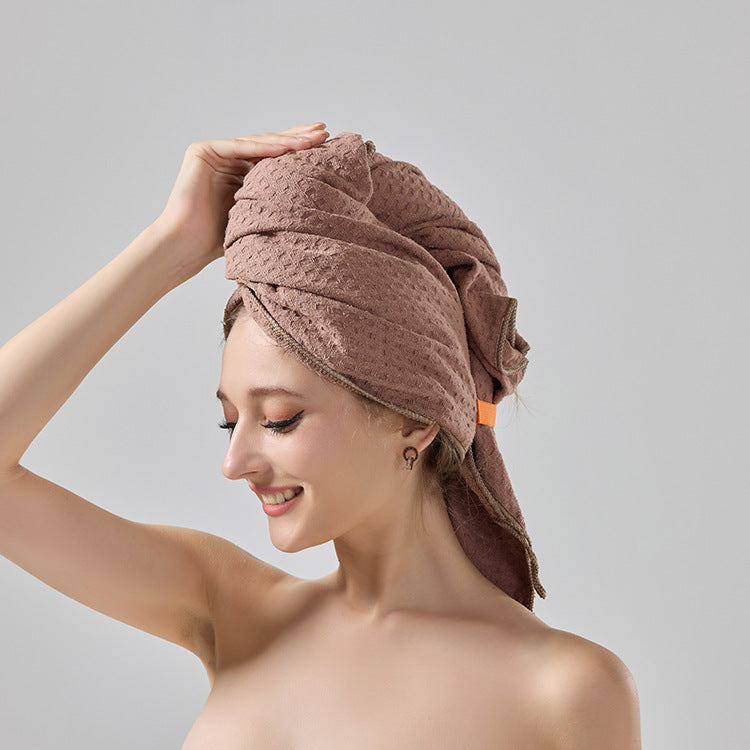 Brown waffle-weave hair turban towel wrapped on head with tied ends