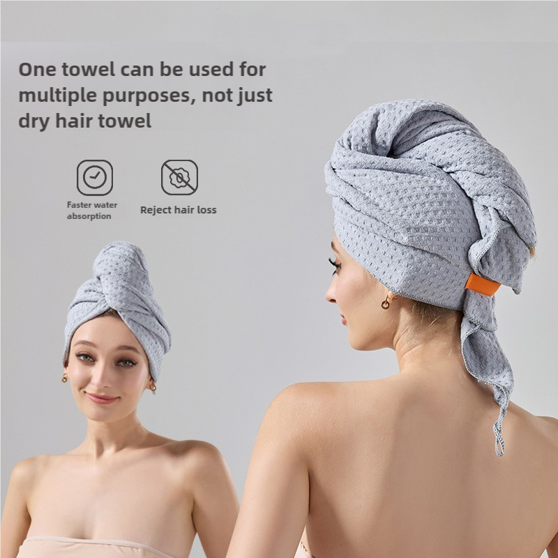 Gray waffle-weave hair turban towel, side wrap with folded layers and trailing ends