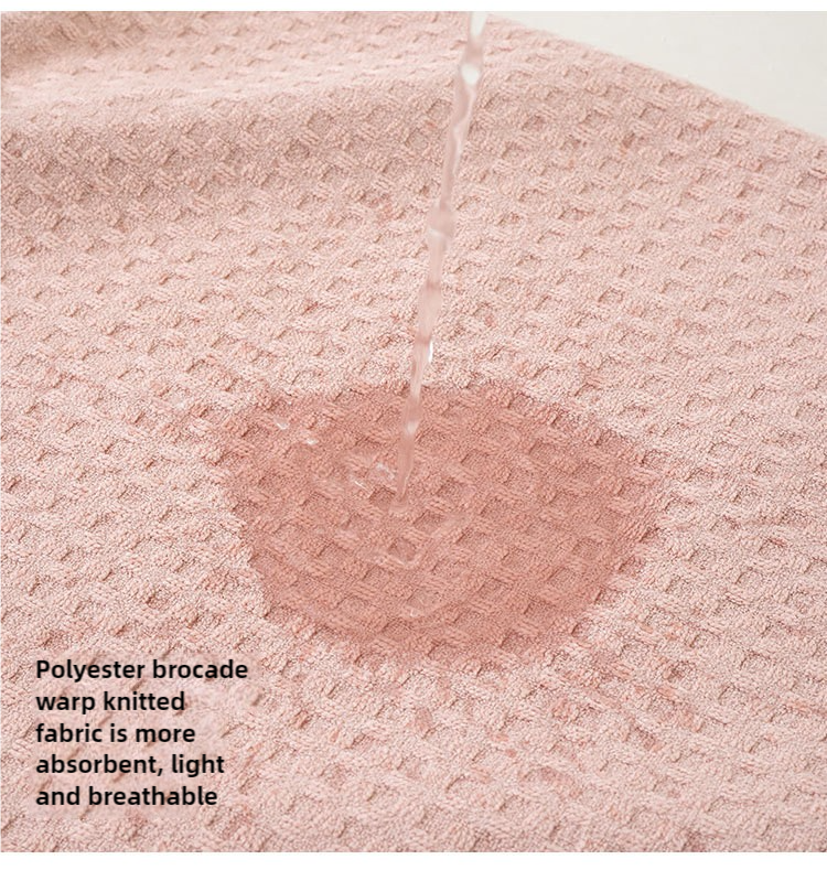 Pink waffle-weave towel fabric with textured diamond pattern