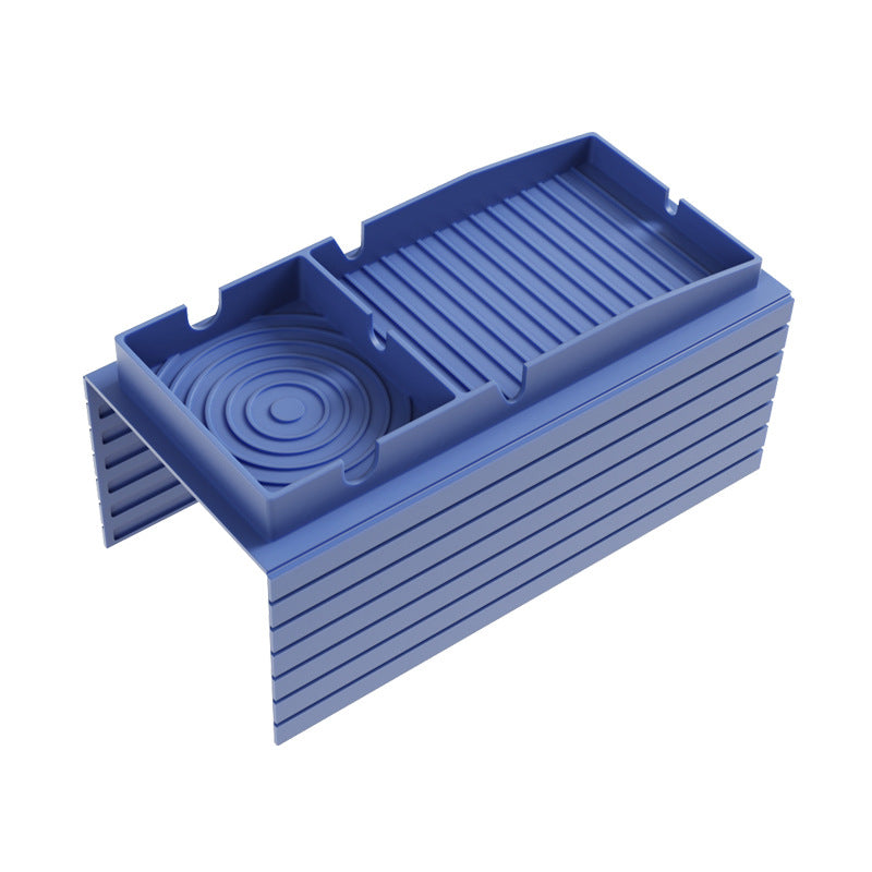 Blue silicone sofa armrest tray with ridged surface and round cup holder insert