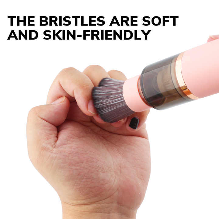 Pink handheld dust vacuum with soft bristles on the cleaning head