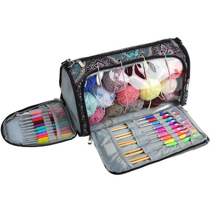 Paisley crochet yarn storage bag open with multiple zip compartments and yarn balls inside