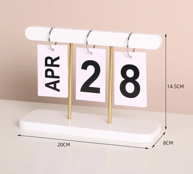 Desktop wooden flip calendar with white frame, month cards APR and date 28