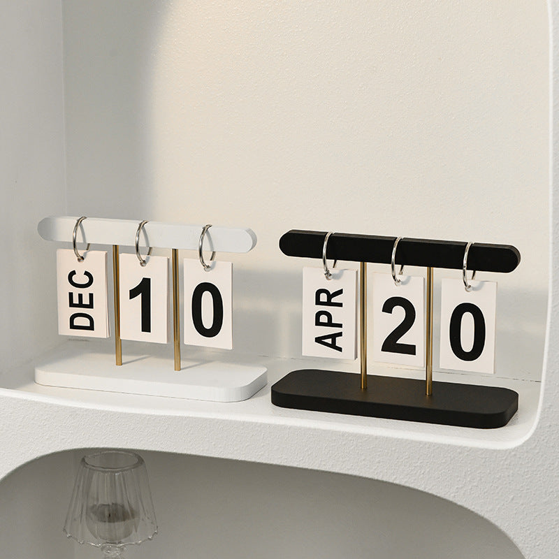 Desktop wooden flip calendar with black top bar, month cards DEC and APR 20