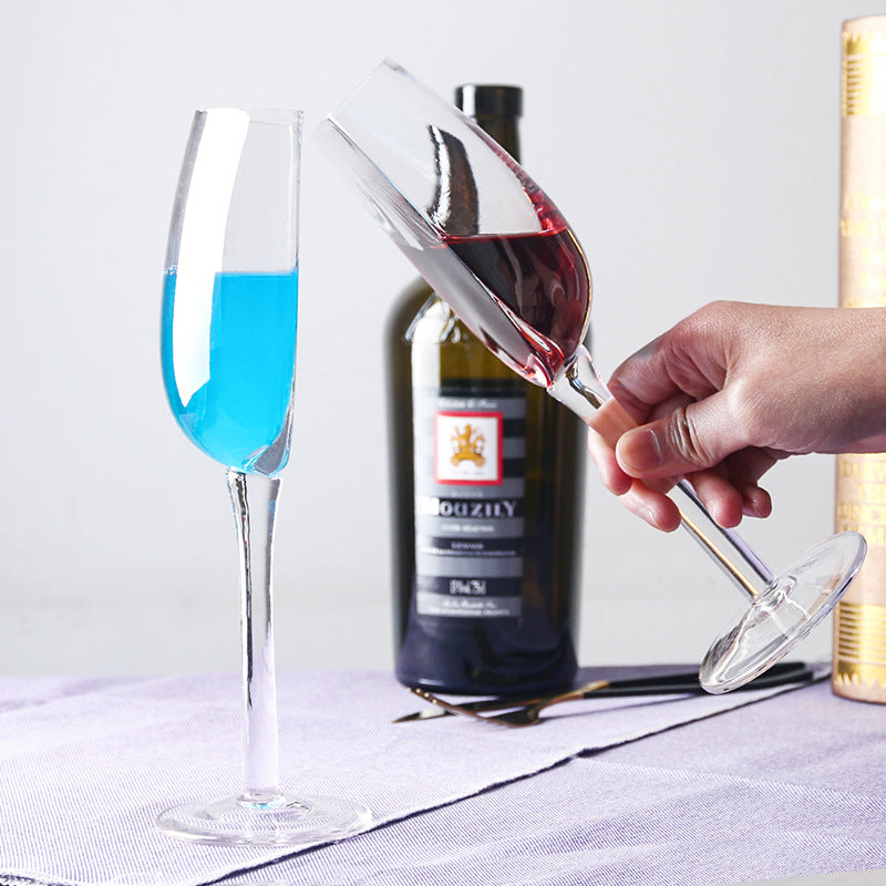 Crystal wine glass with blue drink, clear half-round bowl on a slender stem, round base.