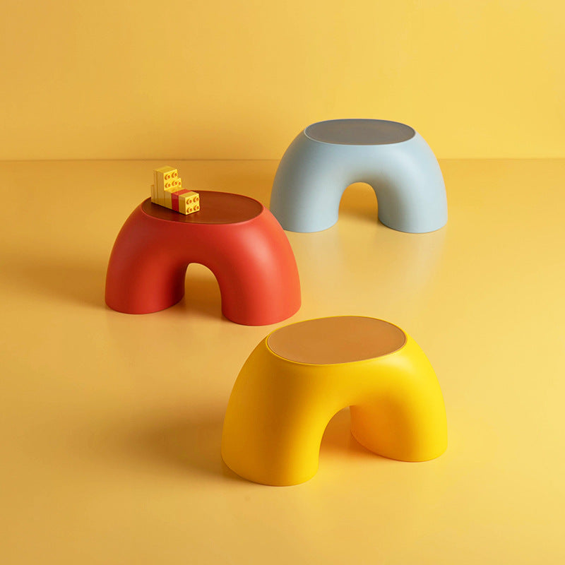 Plastic footstools set: light blue, red, and yellow round stools with arched openings