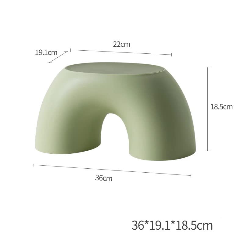 Green round plastic footstool with arched cutout and flat top, wide stable base