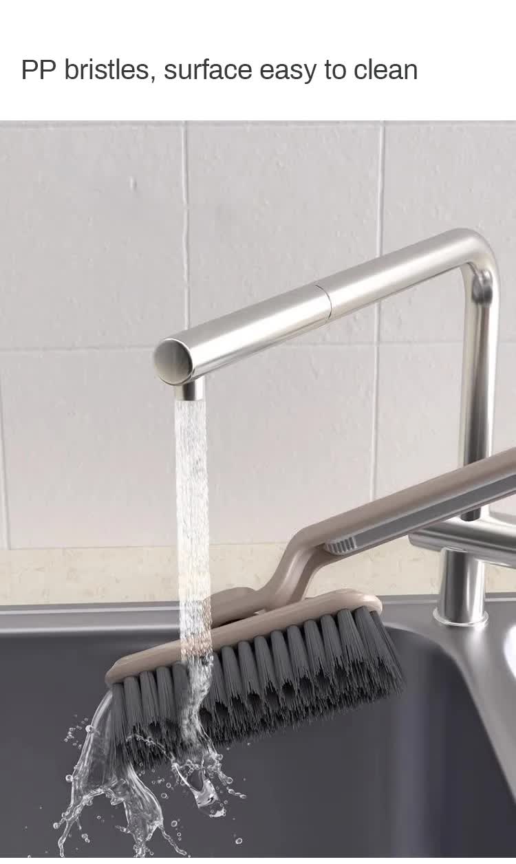 Gray bristle cleaning brush head under running water for easy scrubbing