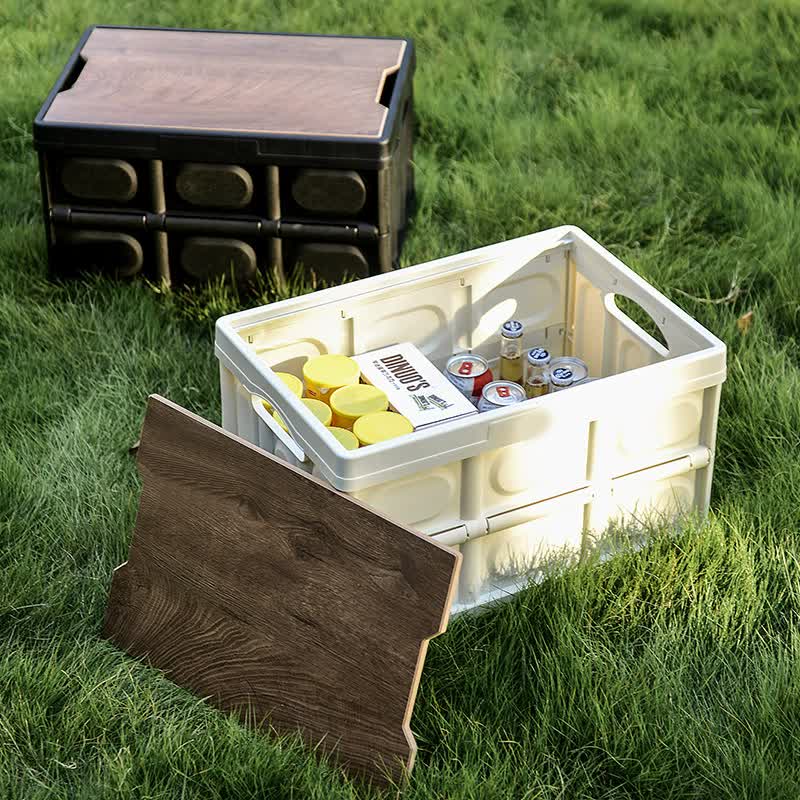 Foldable white storage box open with contents inside; dark wooden lid laid aside