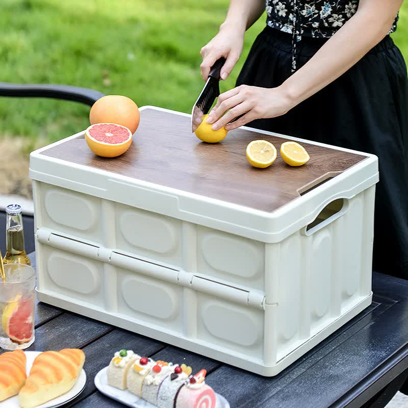 White foldable storage box with wooden lid, used as a tabletop cooler