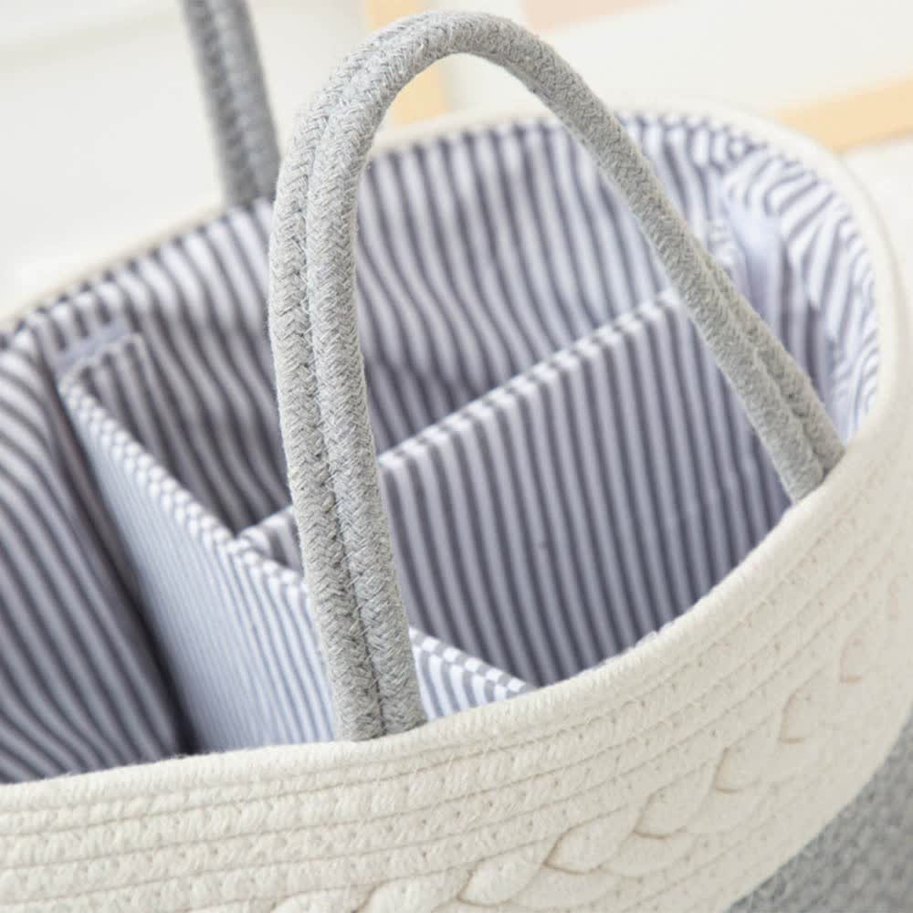 White woven rope basket with curved handle and striped fabric interior lining.